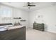 Bright bedroom with a bed, ceiling fan, and decorative shelving, illuminated by natural light through the window at 2305 Sturgeon, Johns Island, SC 29455