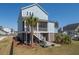 Striking blue two-story home featuring a screened porch and fenced backyard at 2305 Sturgeon, Johns Island, SC 29455