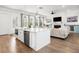Open concept kitchen with island, stainless appliances, and views to the cozy living room at 2305 Sturgeon, Johns Island, SC 29455