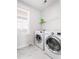 Laundry room equipped with modern washer and dryer units, complemented by marbled floors and ample natural light at 2305 Sturgeon, Johns Island, SC 29455