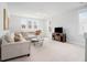 Bright living room featuring a comfortable sofa, a TV, and plenty of natural light from large windows at 2305 Sturgeon, Johns Island, SC 29455