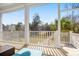 Tranquil porch setting overlooking the backyard with an outdoor sofa and coffee table, ideal for entertaining guests at 2305 Sturgeon, Johns Island, SC 29455