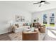 Well-lit living room boasting a neutral color scheme, comfortable seating, and access to the outdoors at 237 Abercom Place Dr, Moncks Corner, SC 29461