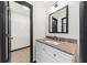 Bathroom vanity with granite counters, white cabinets, and a framed mirror at 2461 Fulford Ct, Mount Pleasant, SC 29466