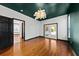 Spacious bedroom featuring hardwood floors, a modern lighting fixture, and French doors at 2461 Fulford Ct, Mount Pleasant, SC 29466