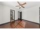 Light-filled bedroom with hardwood floors, ceiling fan, and ensuite bathroom access at 2461 Fulford Ct, Mount Pleasant, SC 29466