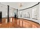 Spacious living room with hardwood floors, dark trim, and lots of natural light and stylish light fixture at 2461 Fulford Ct, Mount Pleasant, SC 29466