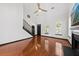 Bright living room featuring hardwood floors, tall ceilings, and staircase with dark trim at 2461 Fulford Ct, Mount Pleasant, SC 29466