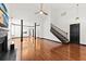 Bright living room featuring hardwood floors, tall ceilings, and a staircase to the upper level at 2461 Fulford Ct, Mount Pleasant, SC 29466