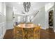 Open-concept dining area with round table, woven chairs, and stylish chandelier at 2552 Josiah St, Daniel Island, SC 29492