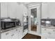 Bright white kitchen with stainless steel appliances and access to the outdoors at 2552 Josiah St, Daniel Island, SC 29492