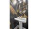 Chic powder room showcases gold leaf wallpaper and pedestal sink at 2552 Josiah St, Daniel Island, SC 29492