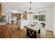 The dining room includes wood floors, a modern chandelier, and sliding glass doors leading to outdoor space at 3025 Penny Ln, Johns Island, SC 29455