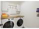 This laundry room features front load washer and dryer, a wood countertop, and white cabinets at 3025 Penny Ln, Johns Island, SC 29455