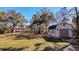 Backyard shed with both garage-style door and walk-in doors on a large green lawn with mature shade trees at 316 Anadale Ct, North Charleston, SC 29418