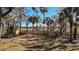Backyard with mature trees, and a new wooden fence defining the property line at 316 Anadale Ct, North Charleston, SC 29418