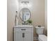 Bathroom vanity features a white cabinet, oval mirror, black hardware, and an adjacent toilet at 316 Anadale Ct, North Charleston, SC 29418