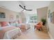 Cozy bedroom featuring two beds, a window seat, tasteful decor, and a ceiling fan for added comfort at 316 Anadale Ct, North Charleston, SC 29418