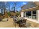 Outdoor wooden deck with seating and dining area perfect for entertaining, with views through the house's large windows at 316 Anadale Ct, North Charleston, SC 29418