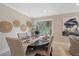 Dining room with an oval table, decorated plates and napkins, and a large window view at 316 Anadale Ct, North Charleston, SC 29418
