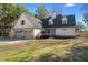 Charming home with a three car garage, manicured lawn, and landscaped front yard at 316 Anadale Ct, North Charleston, SC 29418