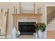 Elegant fireplace with decorative mantle and stone surround, next to staircase at 316 Anadale Ct, North Charleston, SC 29418