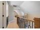 Hallway with a wood and metal railing, leading to a cozy sitting area bathed in natural light at 316 Anadale Ct, North Charleston, SC 29418