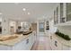 Bright kitchen features white cabinets, marble countertops, stainless steel appliances and eat-in island at 316 Anadale Ct, North Charleston, SC 29418