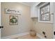 Laundry room with a decorated wreath, laundry sign, a window, and storage on the wall at 316 Anadale Ct, North Charleston, SC 29418