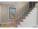 Staircase features black metal railings, light wood treads, white risers, and a window view at 316 Anadale Ct, North Charleston, SC 29418