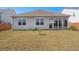 Backyard of the property featuring a patio area and a well-maintained lawn at 316 Knawl Road, Moncks Corner, SC 29461