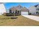 Charming single Gathering home featuring brick accents, a two-car garage, and a well-manicured lawn at 316 Knawl Road, Moncks Corner, SC 29461