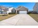 Charming single Gathering home featuring brick accents, a two-car garage, and a well-manicured lawn at 316 Knawl Road, Moncks Corner, SC 29461