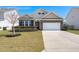 Charming single Gathering home featuring brick accents, a two-car garage, and a well-manicured lawn at 316 Knawl Road, Moncks Corner, SC 29461