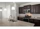 Close-up of a kitchen with a granite-topped island, stainless steel appliances, and dark cabinets at 316 Knawl Road, Moncks Corner, SC 29461
