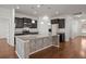 Well-equipped kitchen with dark wood cabinets, granite counters, and stainless steel appliances at 316 Knawl Road, Moncks Corner, SC 29461