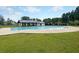 Relaxing community pool area with a spacious deck, covered seating, and mature trees at 316 Knawl Road, Moncks Corner, SC 29461