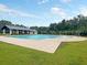 Community pool featuring a large swimming area, spacious deck, covered seating and mature trees at 316 Knawl Road, Moncks Corner, SC 29461