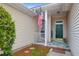 Welcoming front porch with colorful rug, a decorative wreath and an American flag at 3244 Hunters Rest Drive Dr, Charleston, SC 29414