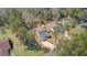 Aerial view of a home with a long driveway, fenced backyard, and mature trees in a peaceful setting at 3473 Plow Ground Rd, Johns Island, SC 29455