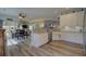 Bright, open concept kitchen with dining area, white cabinetry, stainless appliances, and hardwood floors at 3473 Plow Ground Rd, Johns Island, SC 29455