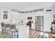 Beautiful white kitchen with stainless steel appliances, island seating, and wood-style floors at 3473 Plow Ground Rd, Johns Island, SC 29455