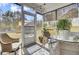 Enclosed screened porch features wicker chairs and a glass table creating an outdoor dining and relaxing space at 3473 Plow Ground Rd, Johns Island, SC 29455