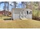 White storage shed with double doors and a small window nestled in a spacious backyard at 3473 Plow Ground Rd, Johns Island, SC 29455