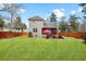 Well-maintained backyard with green grass, a wooden privacy fence, and outdoor seating area at 3545 Rookwood Pl, Johns Island, SC 29455