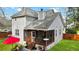 Back porch overlooking a green backyard with outdoor seating and mature trees at 3545 Rookwood Pl, Johns Island, SC 29455
