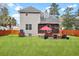 Green backyard featuring a screened in porch, patio seating, and privacy fence at 3545 Rookwood Pl, Johns Island, SC 29455