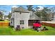 Spacious backyard with a covered porch, outdoor seating, green lawn, and privacy fence at 3545 Rookwood Pl, Johns Island, SC 29455