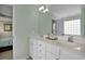 Bathroom with double vanity sinks, large mirror and views of a bedroom with a bed at 3545 Rookwood Pl, Johns Island, SC 29455