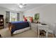 Bright bedroom with a window, blue bedding, bedside tables, and a white desk area at 3545 Rookwood Pl, Johns Island, SC 29455